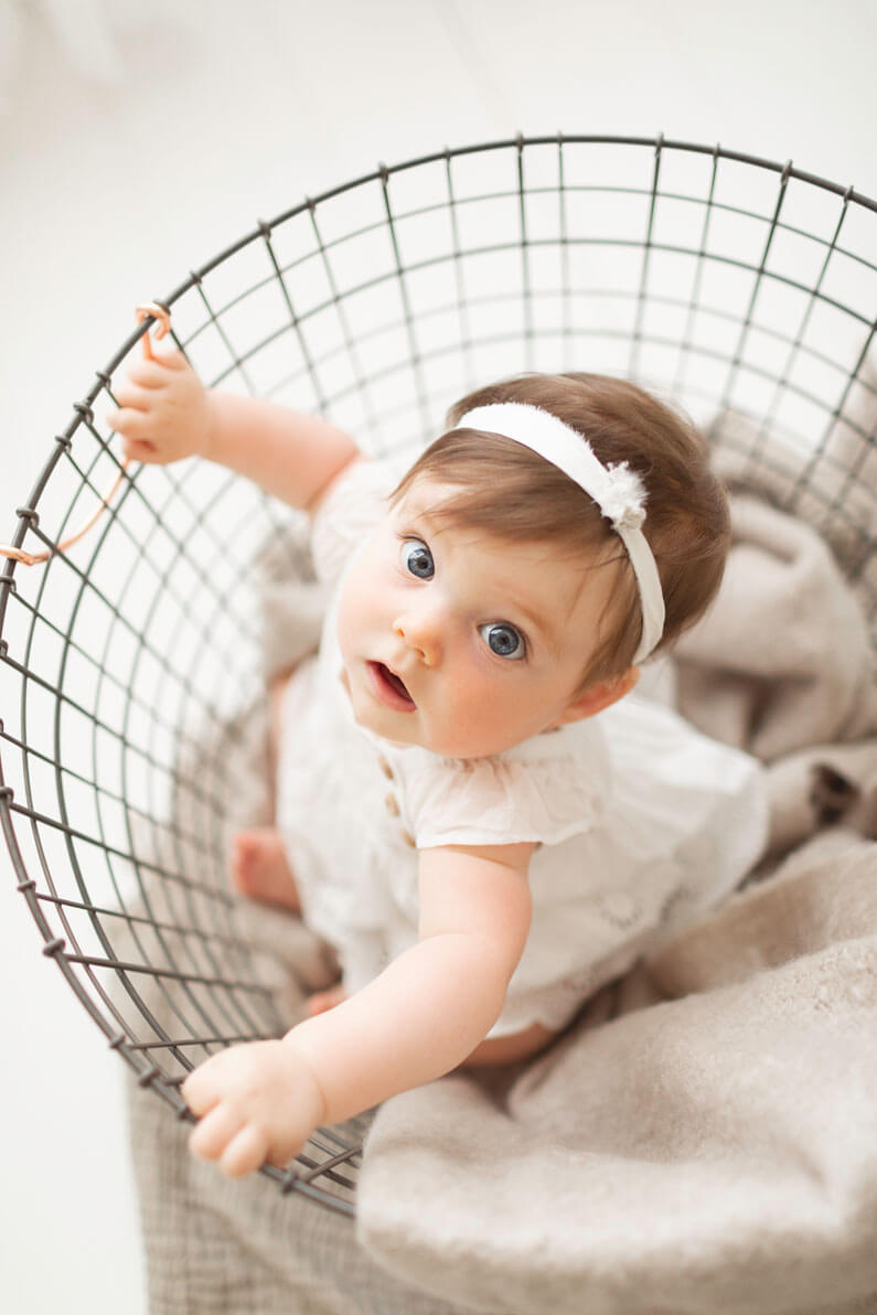 image of 6 month old baby in a basket during family photographer birmingham al