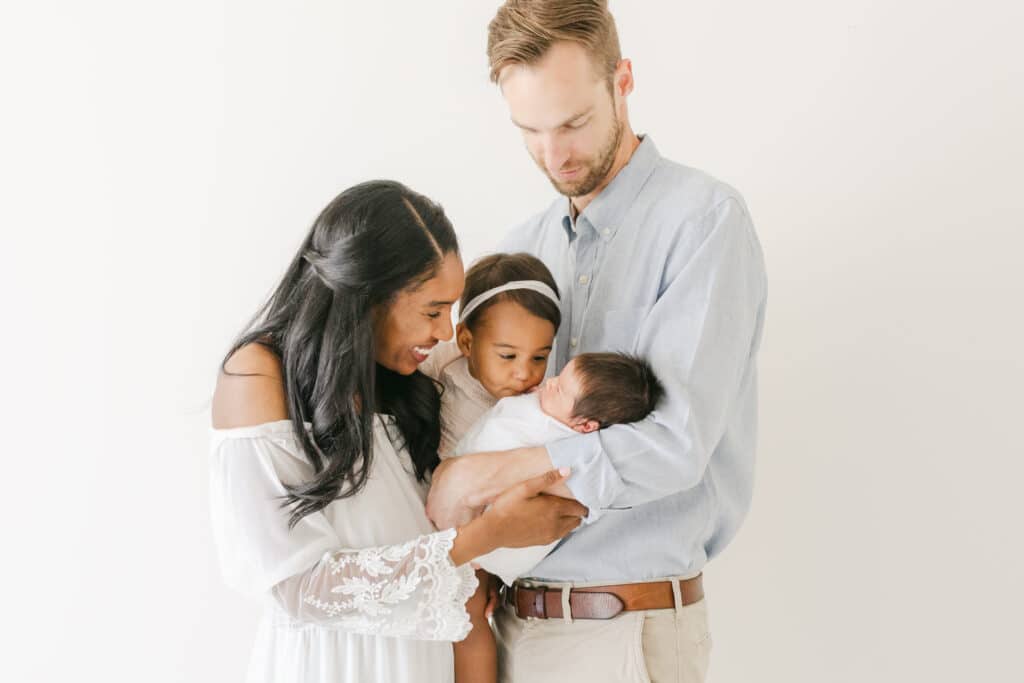 Qualities to look for in Omaha Midwives image of family with brand new baby