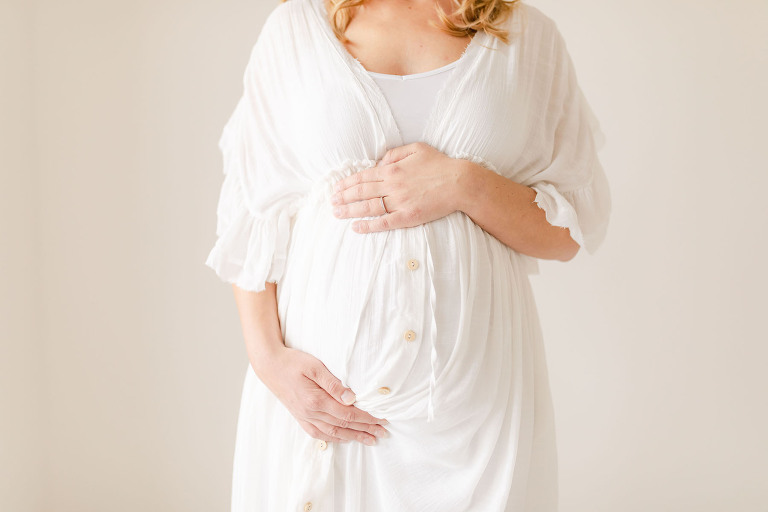 birmingham maternity stores mama holding belly in a gorgeous white gown