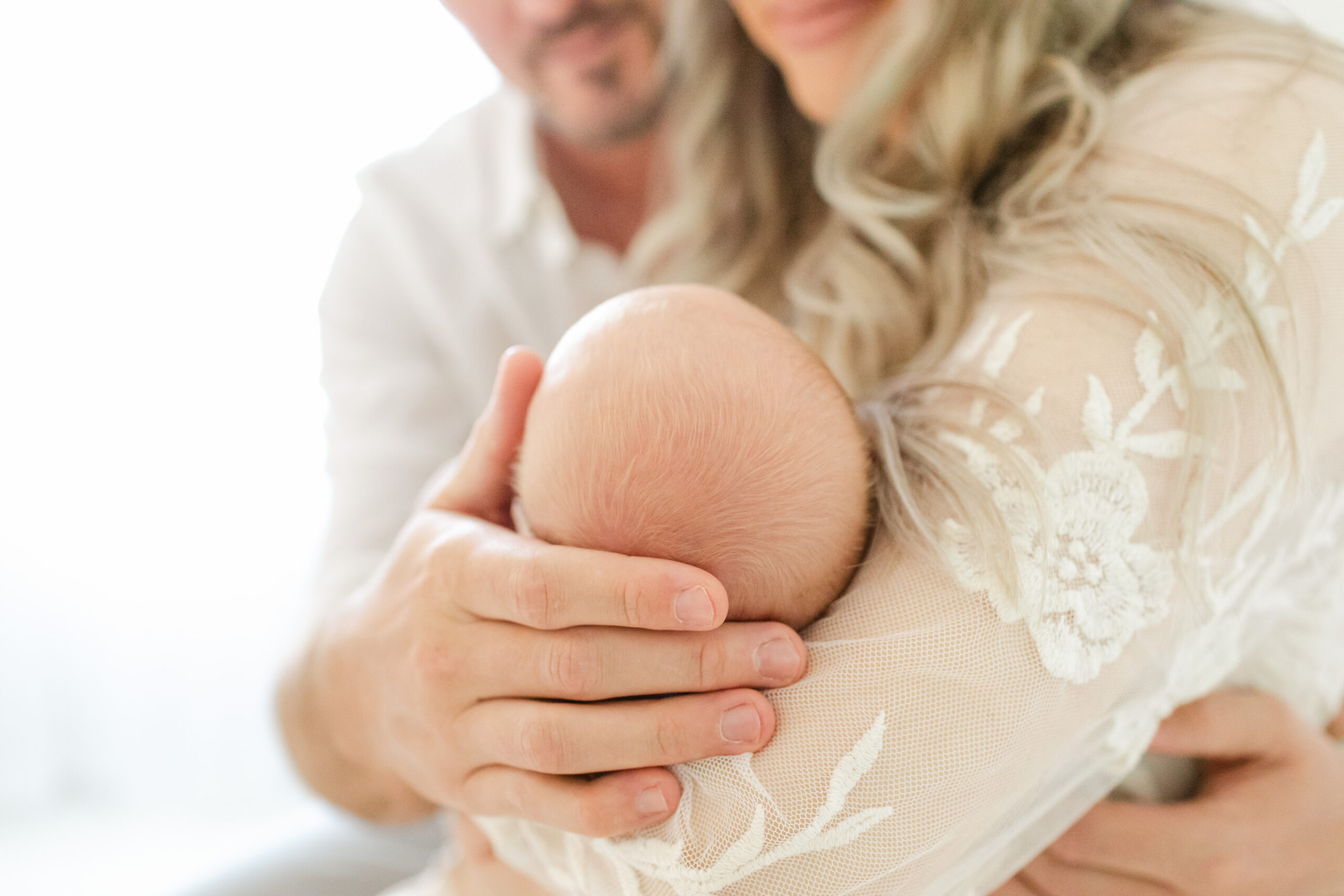 Image of a new family cuddling their baby that might be seen at st vincent women's and children's center in Vestavia