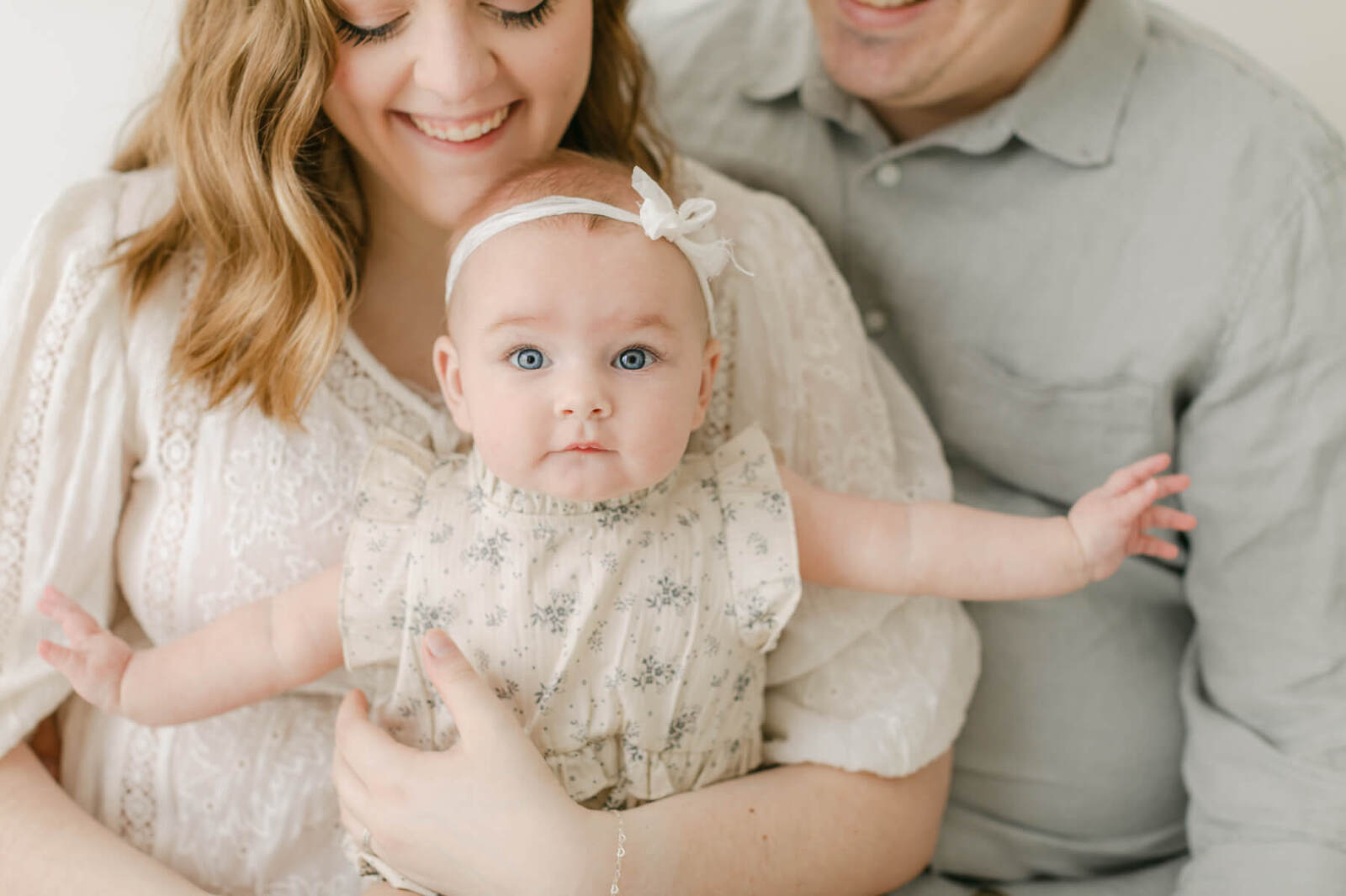 Image of baby with mom and dad by newborn photographer in montgomery AL Virginia Schultz