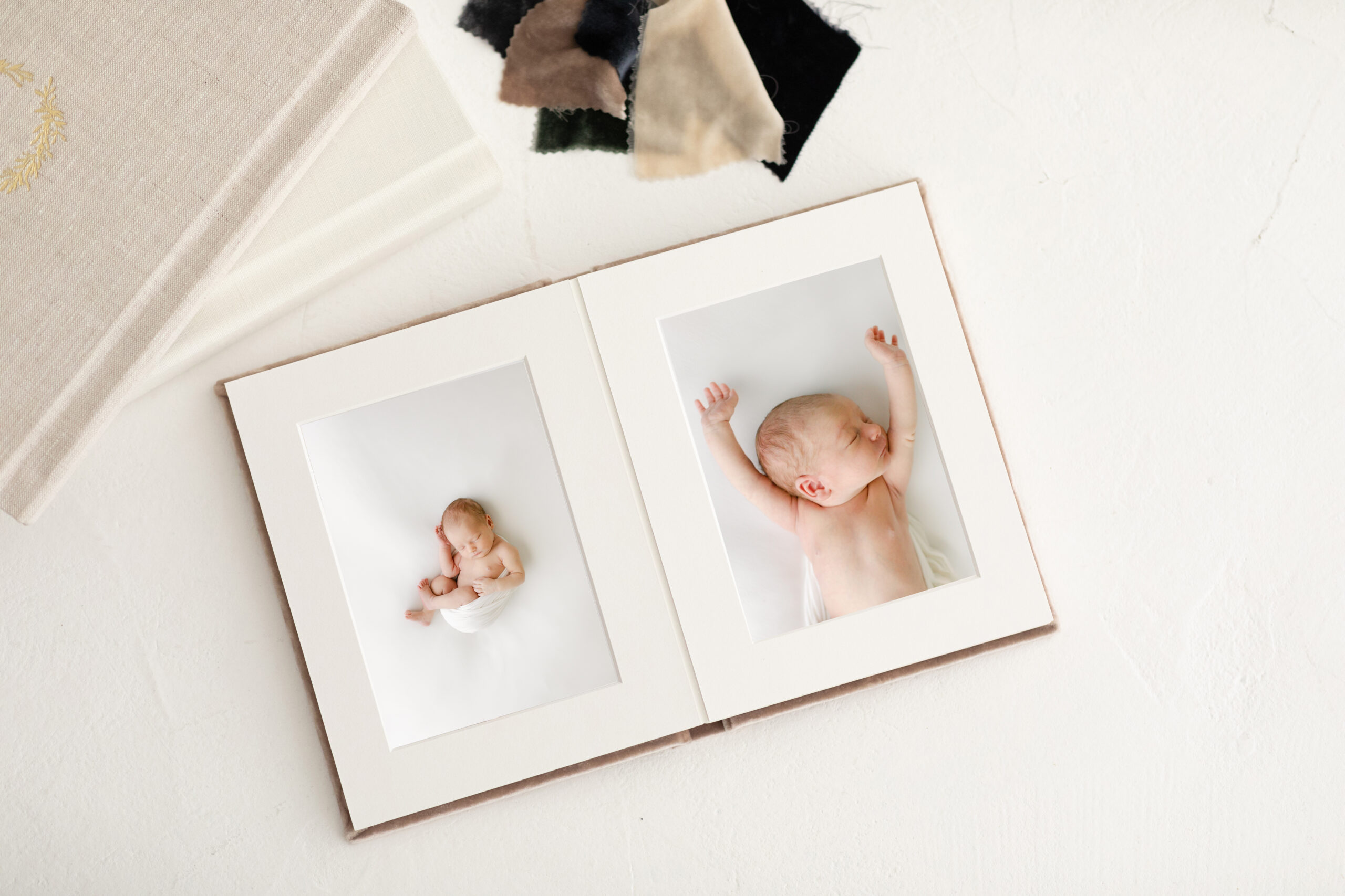 image of fine art matted prints delivered in linen box ready to be framed at home after your newborn photographer session in central Alabama