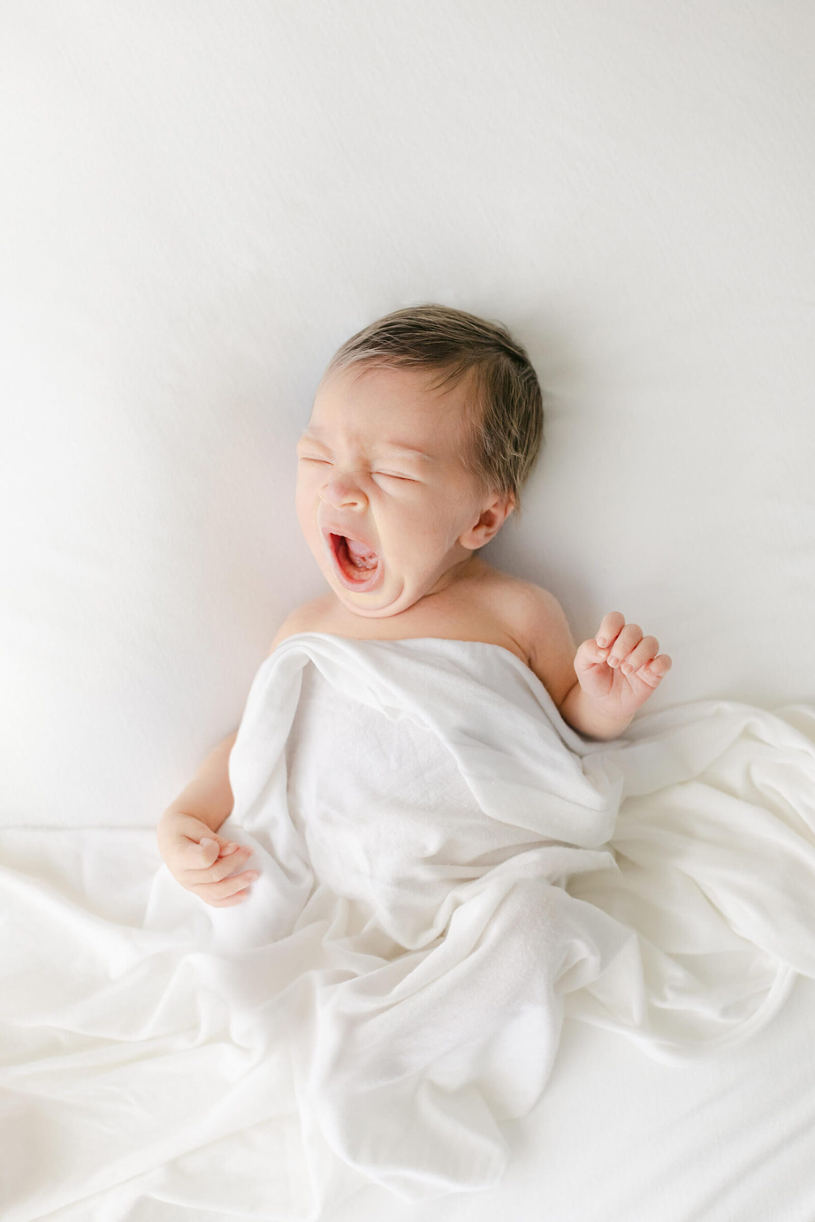 nebraska photographer captures newborn yawn on white background
