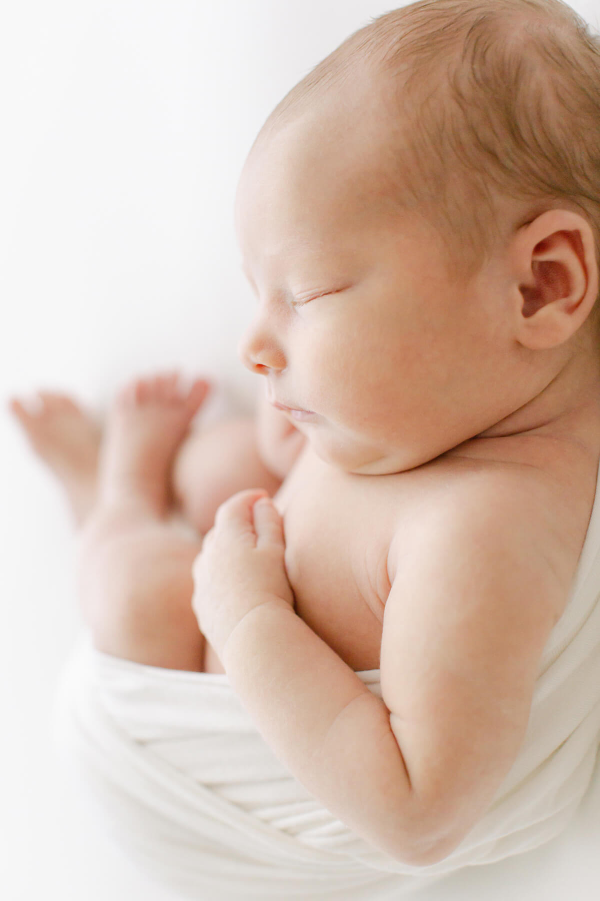 newborn baby sleeps as photographer Virginia Schultz gets detailed images