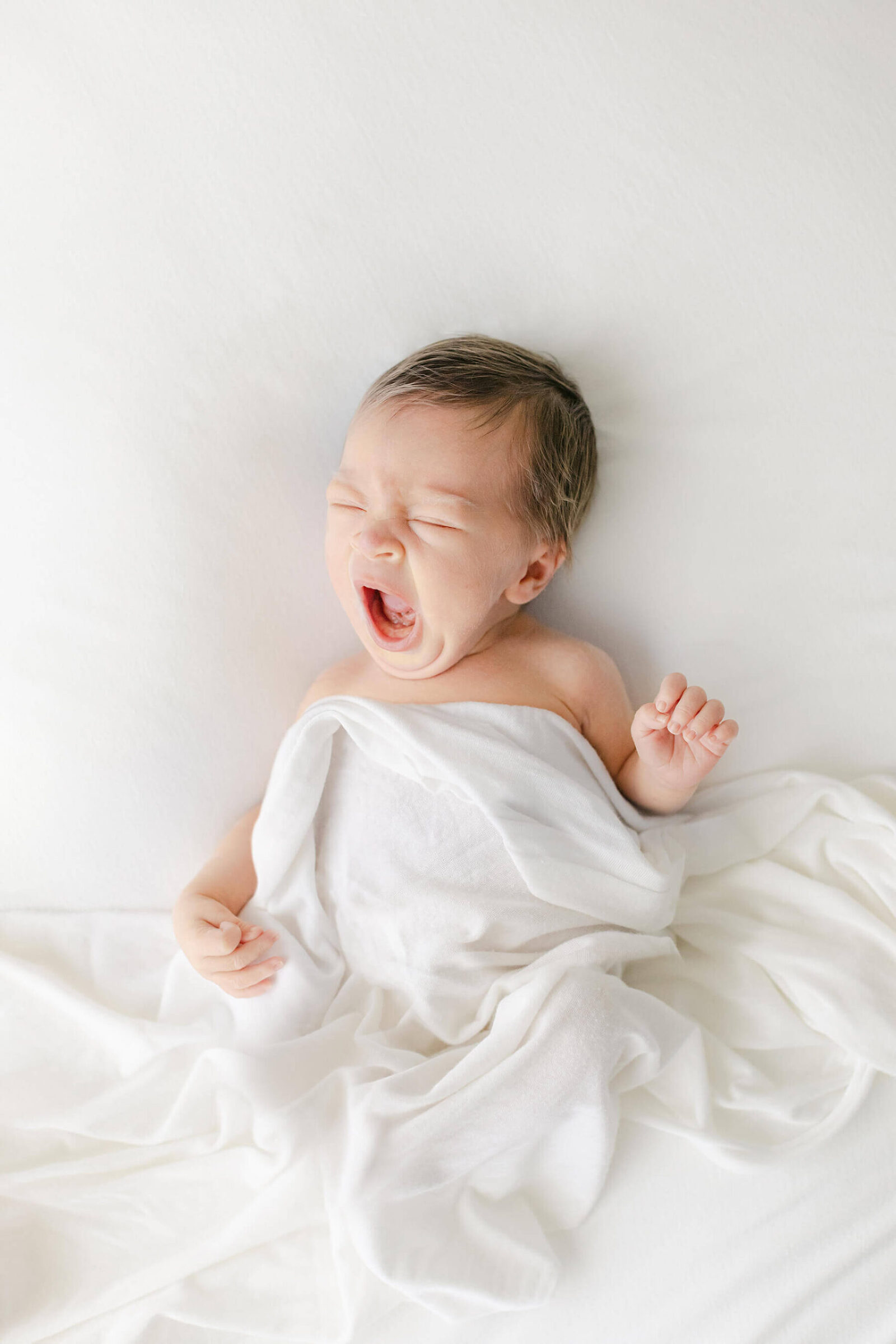 newborn baby yawns during omaha newborn photographer session