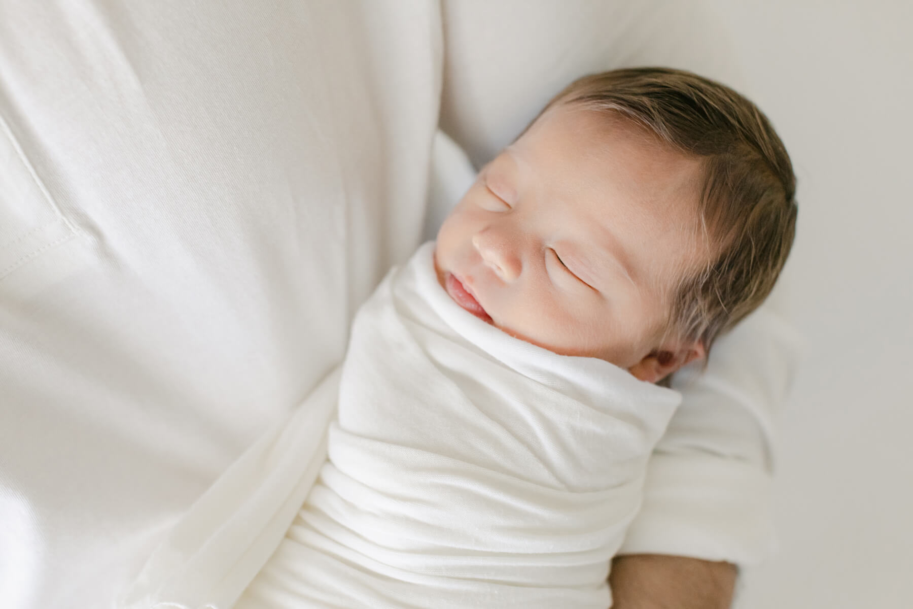 Newborn photographer creating timeless portraits