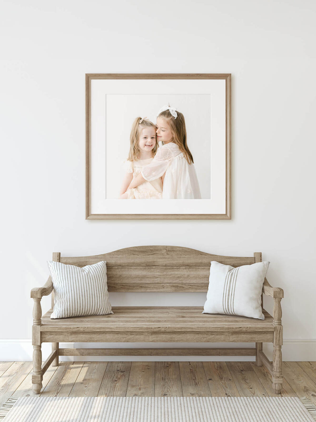 entryway to gorgeous light filled home features a photograph of two girls from a recent family session