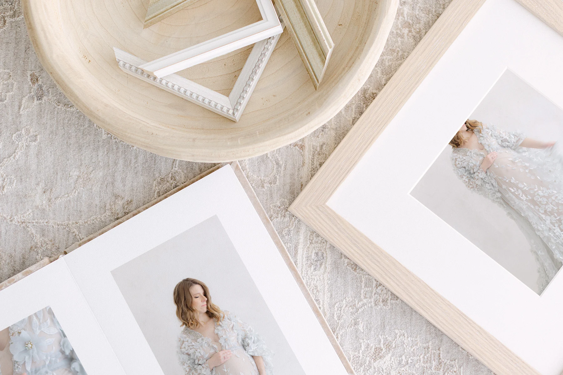 Handmade heirloom album beside a framed newborn print, designed for an Omaha family
